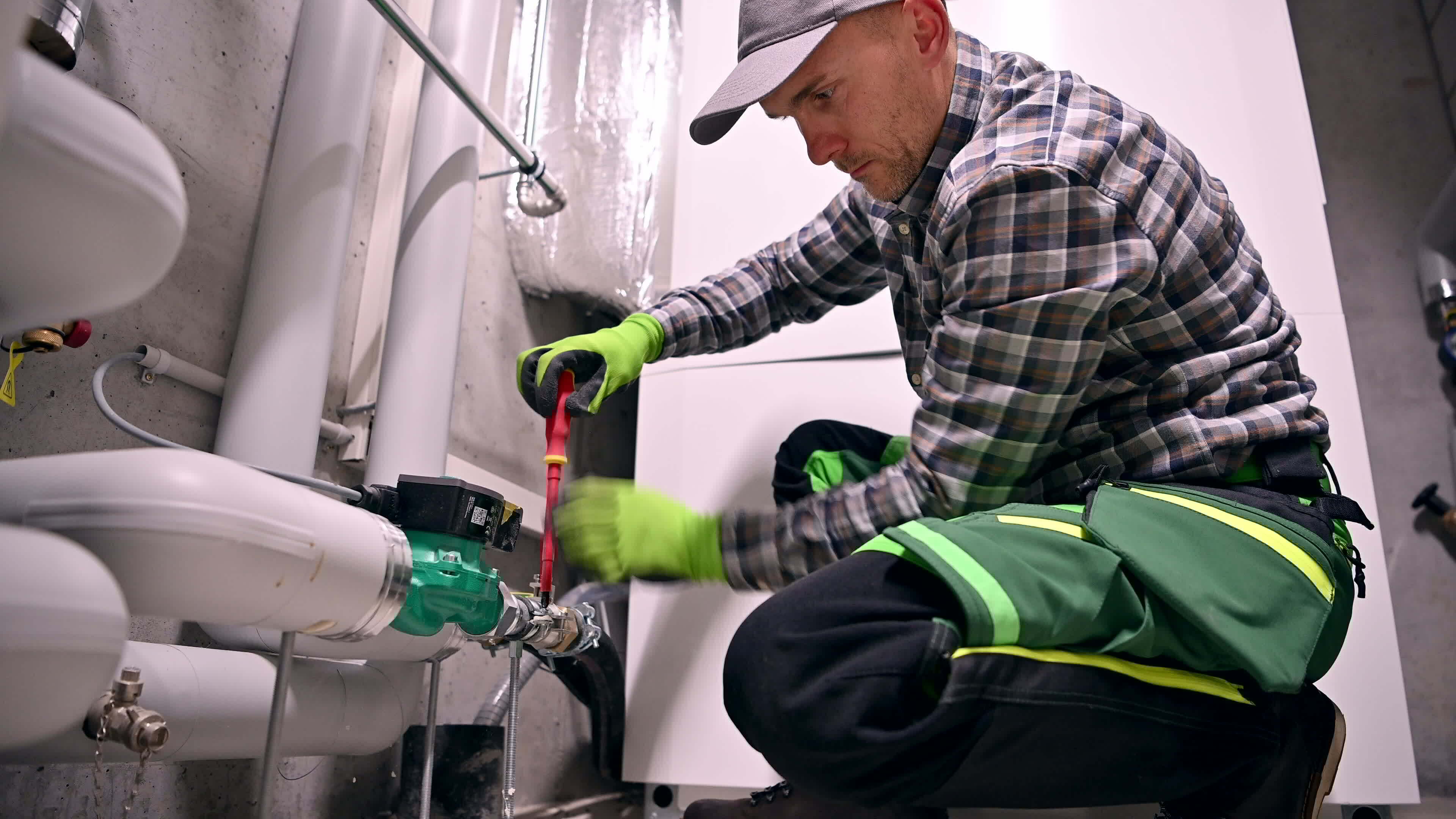 Professional plumber at work repairing plumbing system